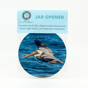 A flying pelican over the ocean photograph on a jar opener