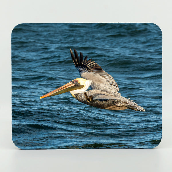 A flying pelican over the ocean photograph on a mouse pad