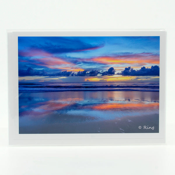 Early morning sunrise over the ocean sea photograph on a  greeting card