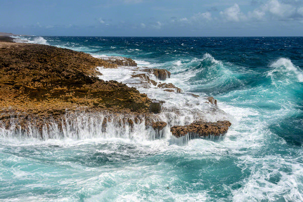 A photo of large crashing waves along the rocky windward coast on the island of Curacao