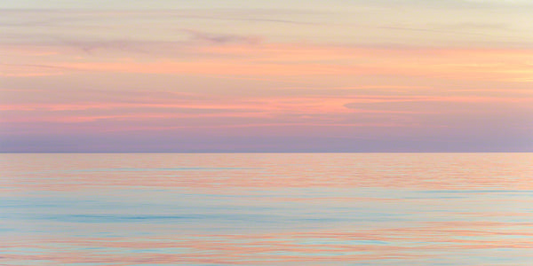 A photo of colorful sunset light on the water in the Caribbean