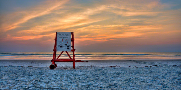 A photo of a life guard stand at sunrise