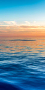 A photo of sunset light over calm blue Caribbean waters
