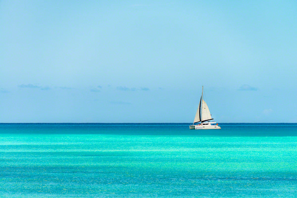 A sailboat taking tourists for a peaceful ride along the coast in Antigua