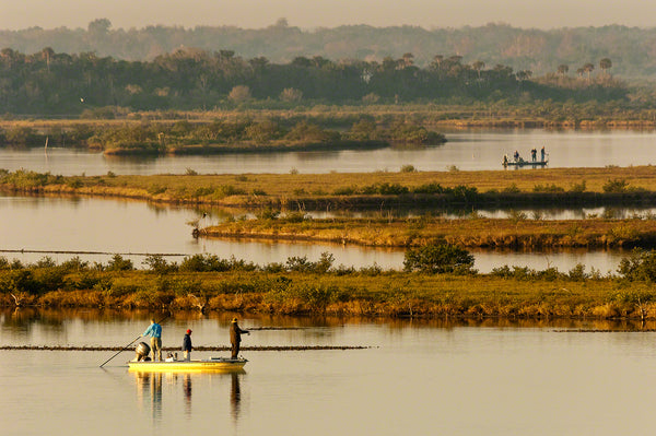 A photo of flats fisherman fishing the shallows in Mosquito Lagoon