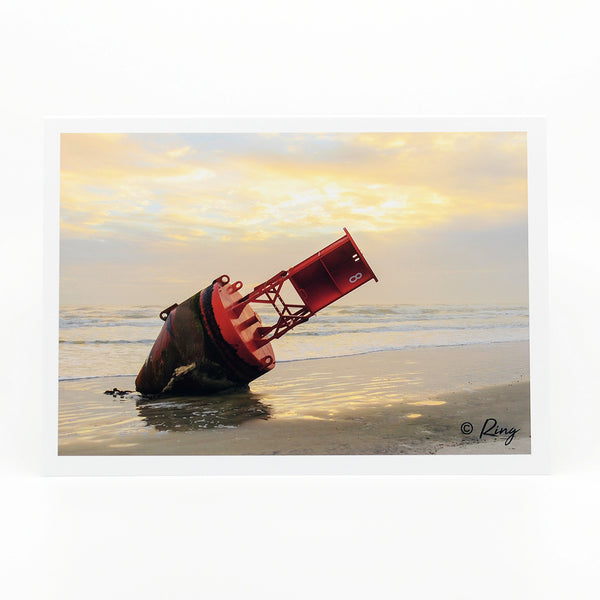 Red Buoy on the shore photograph on a greeting card