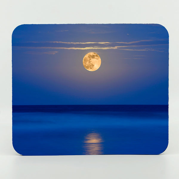 A super moon rising over the ocean sea photograph on a  mouse pad