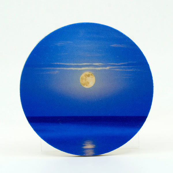 A super moon rising over the ocean sea photograph on a round rubber home coaster
