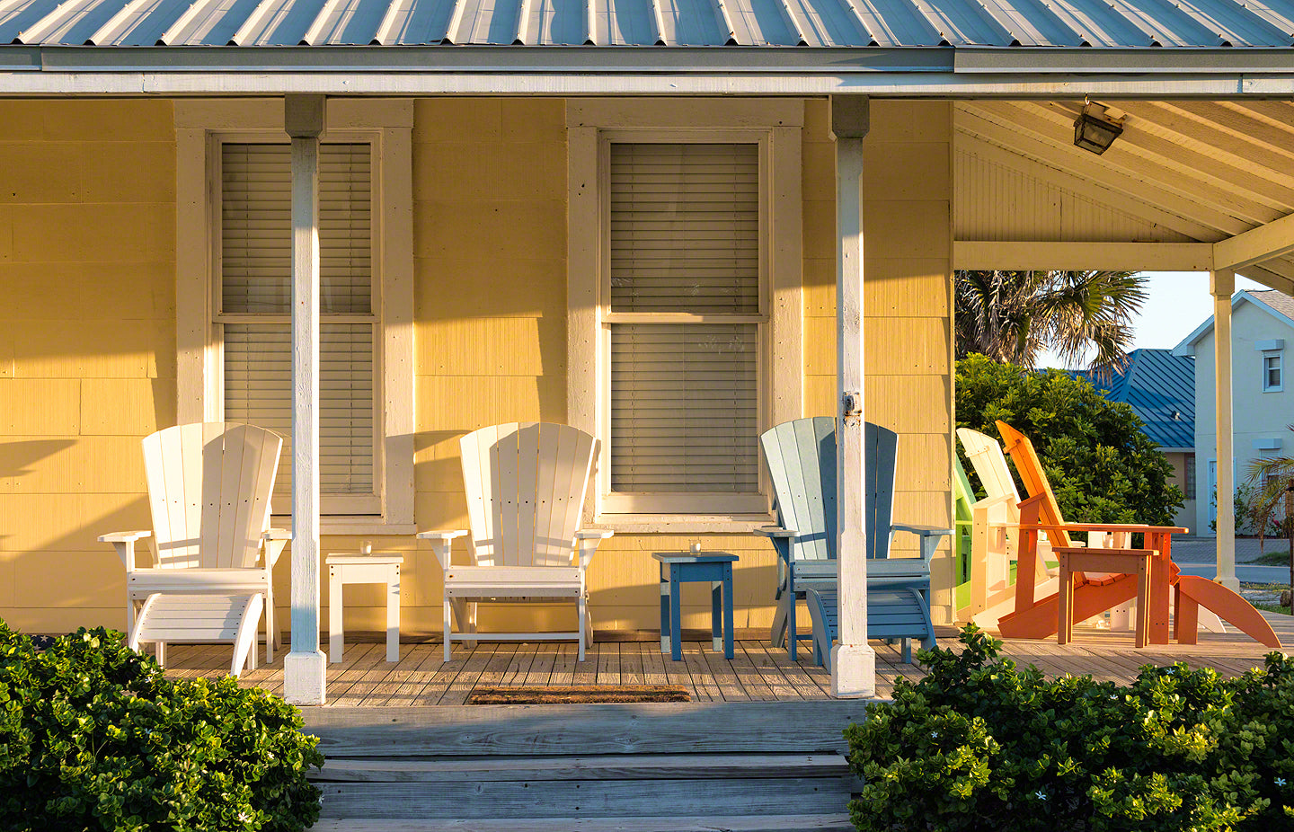 A photo of Adirondack Chairs on the porch of an old Florida home