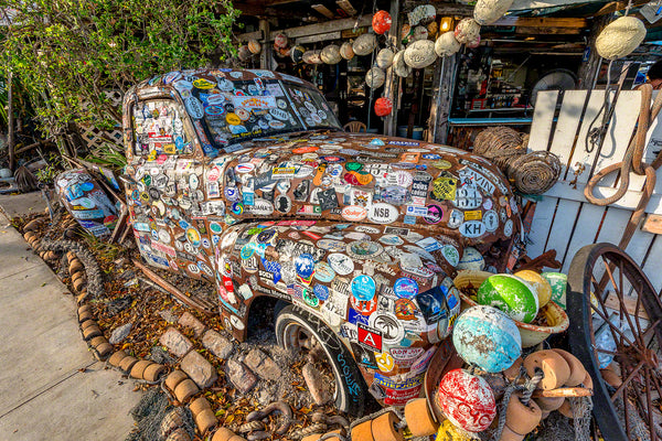 A photo of an old truck with stickers all over it at Bo's Fish Wagon restaurant in Key West Florida