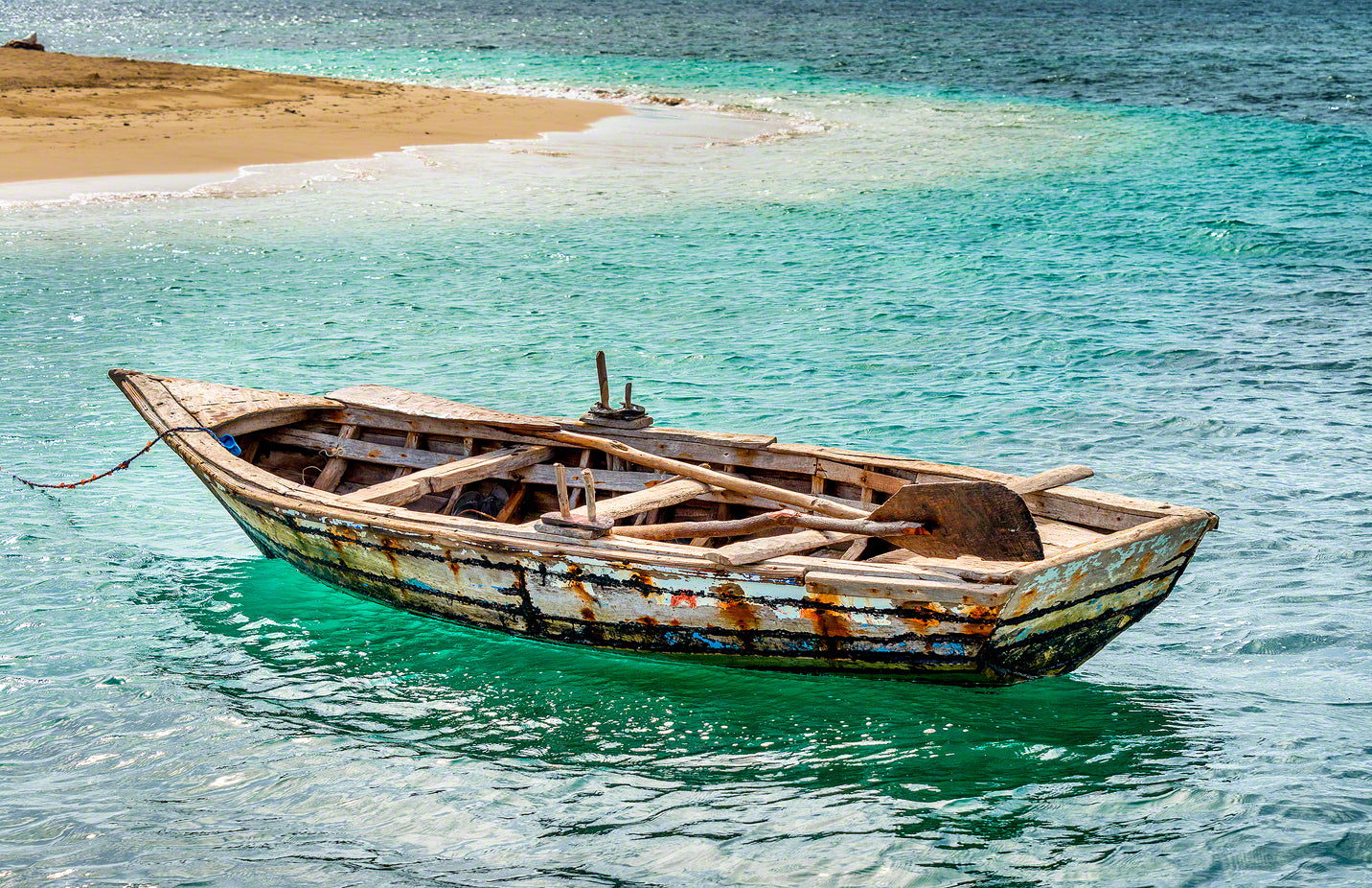 A photo of a rustic Haitian fisherman's boat in beautiful Caribbean water