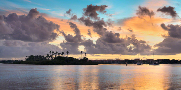 A sunrise view of Chicken Island and sailboats in the Indian River waterway.