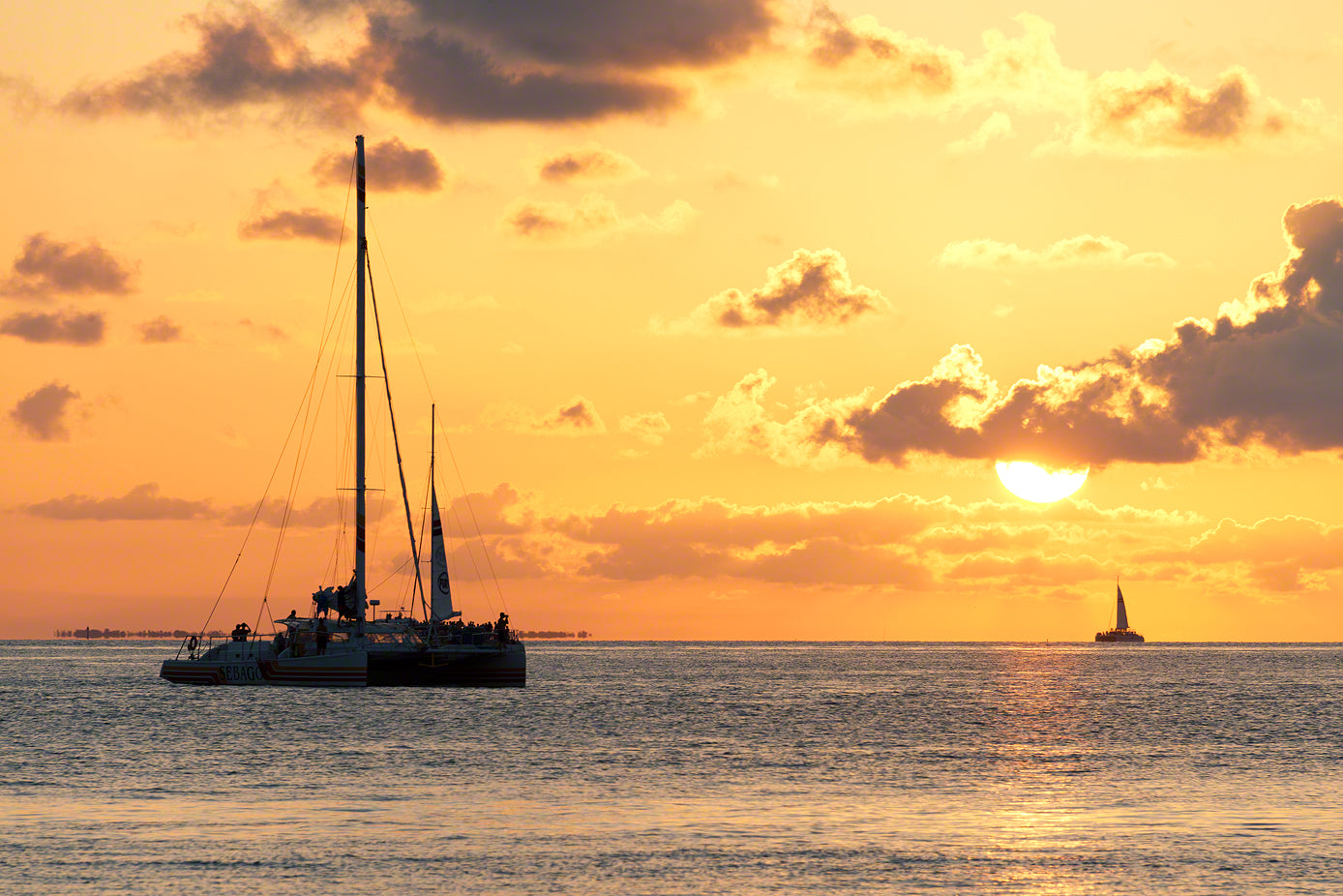 A photo of sailboats watching the sunset celebration in Key West, Florida