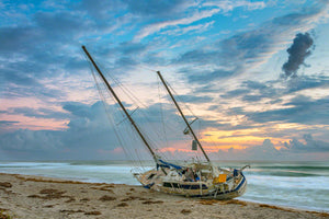 A photo of a beached sailboat after a hurricane