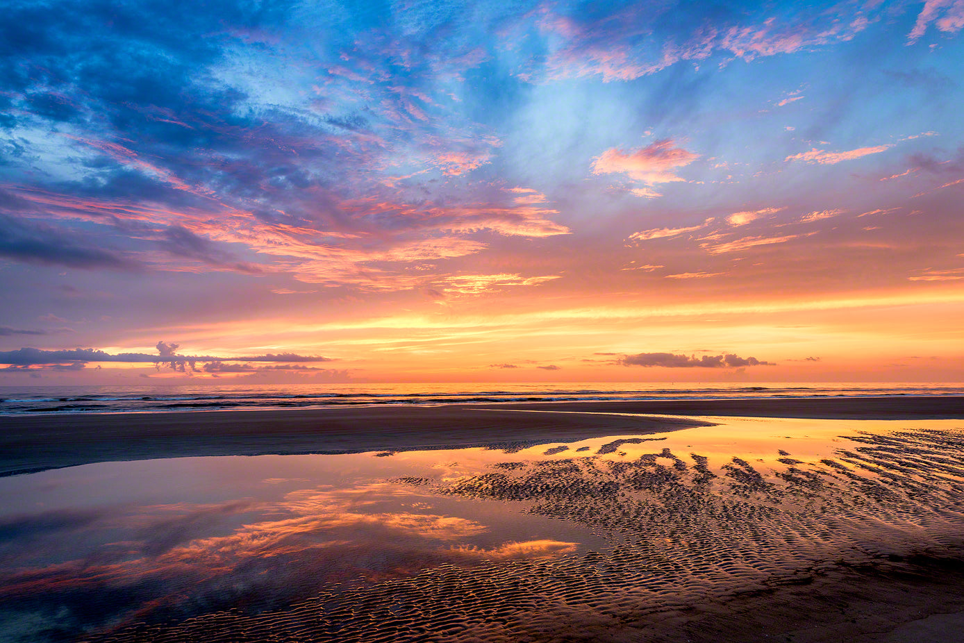 A photo of a beautiful sunrise on the beach in New Smyrna Beach