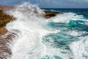 A photo of large crashing waves along the rocky windward coast on the island of Curacao