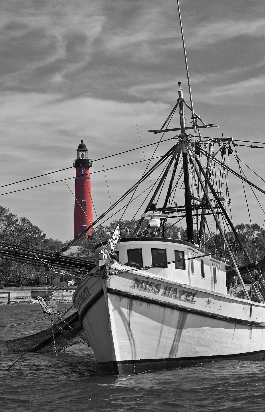 A photo of the Ponce Inlet Lighthouse with the Miss Hazel shrimp boat