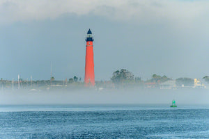 A photo of the Ponce Inlet Lighthouse with sea fog