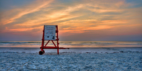 A photo of a life guard stand at sunrise