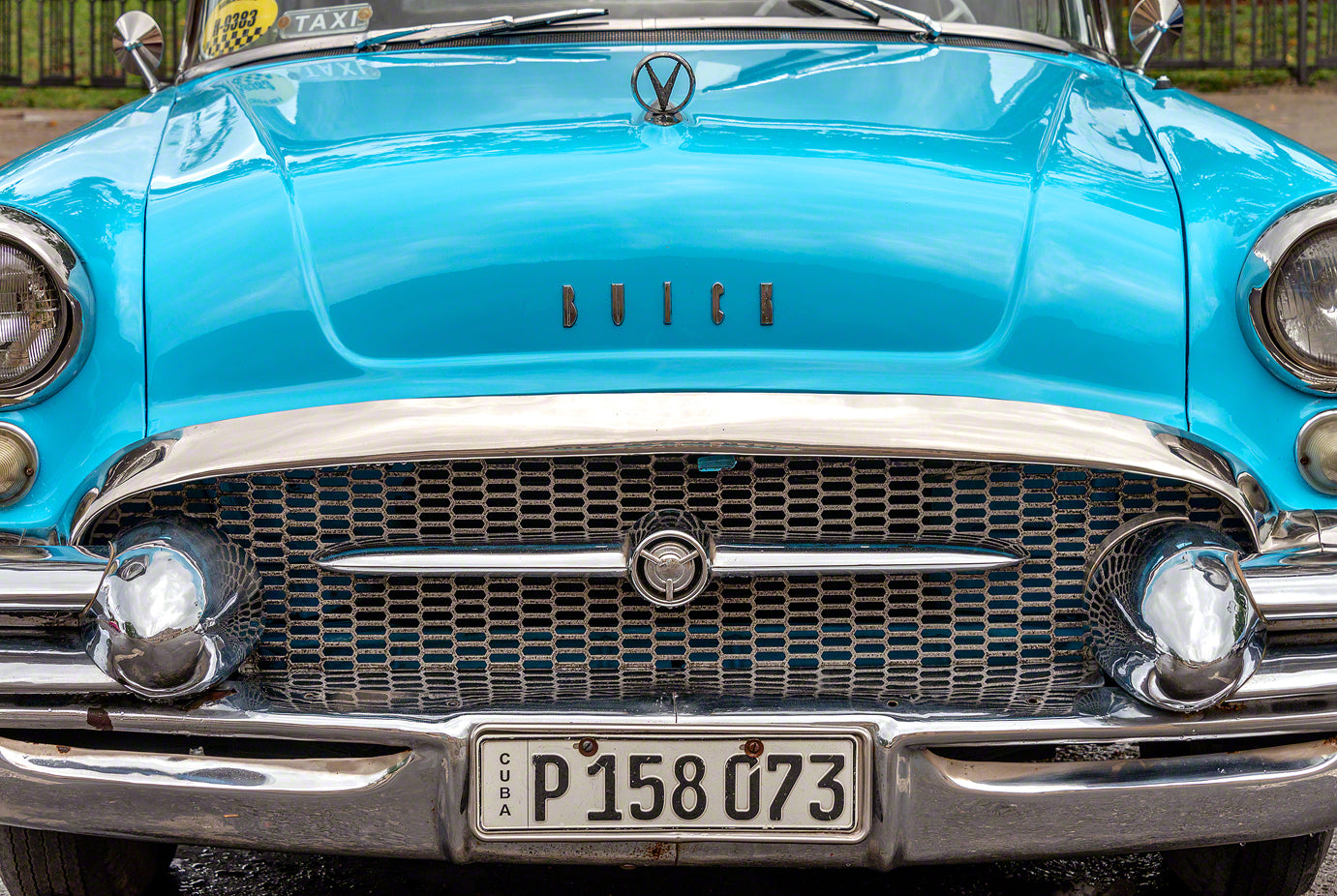 A photo of an old classic American car used as a taxi in Cuba